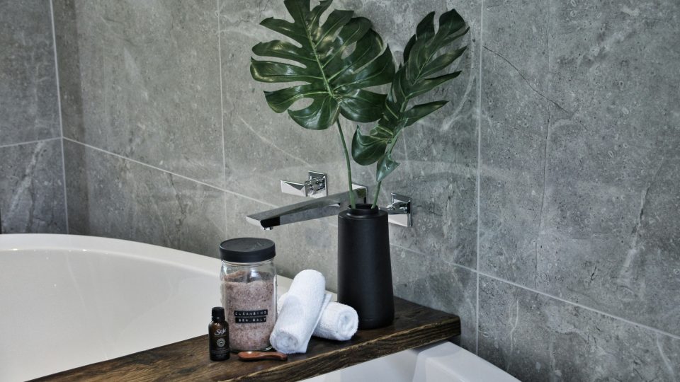 white ceramic bathtub with soap bottles